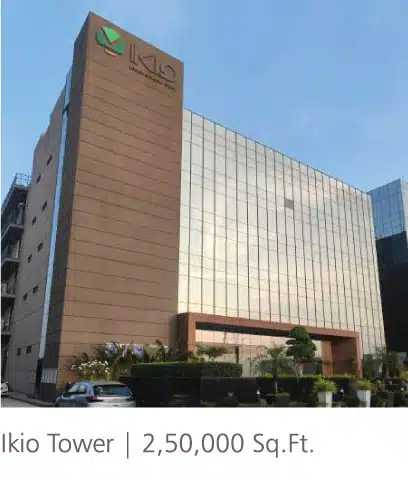 Ikio Tower 250,000 sq ft commercial office building featuring reflective glass curtain wall and entrance landscaping