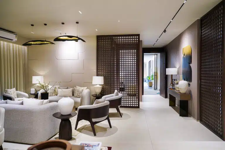 Gulnaar Zenium elegant living room with plush seating, sculptural pendant lights and decorative wooden lattice screens