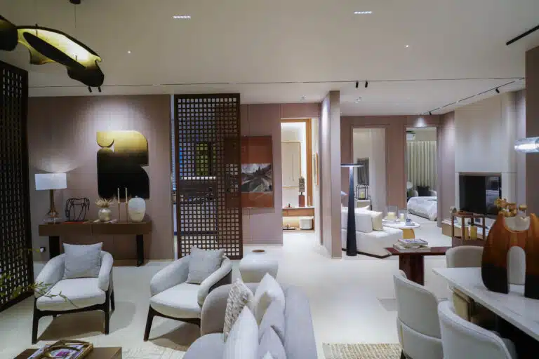 Contemporary open-plan living room rendering by Gulnaar Zenium with neutral seating, partition screens and warm lighting