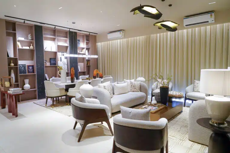 Gulnaar Zenium elegant living-dining interior with soft sofas, dining table, open shelving and sculptural pendant lights