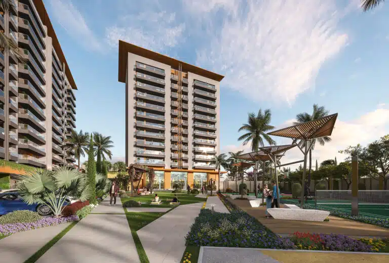 Gulnaar Zenium 4+1 BHK exterior with landscaped garden, palm trees, outdoor seating and modern high-rise apartment towers